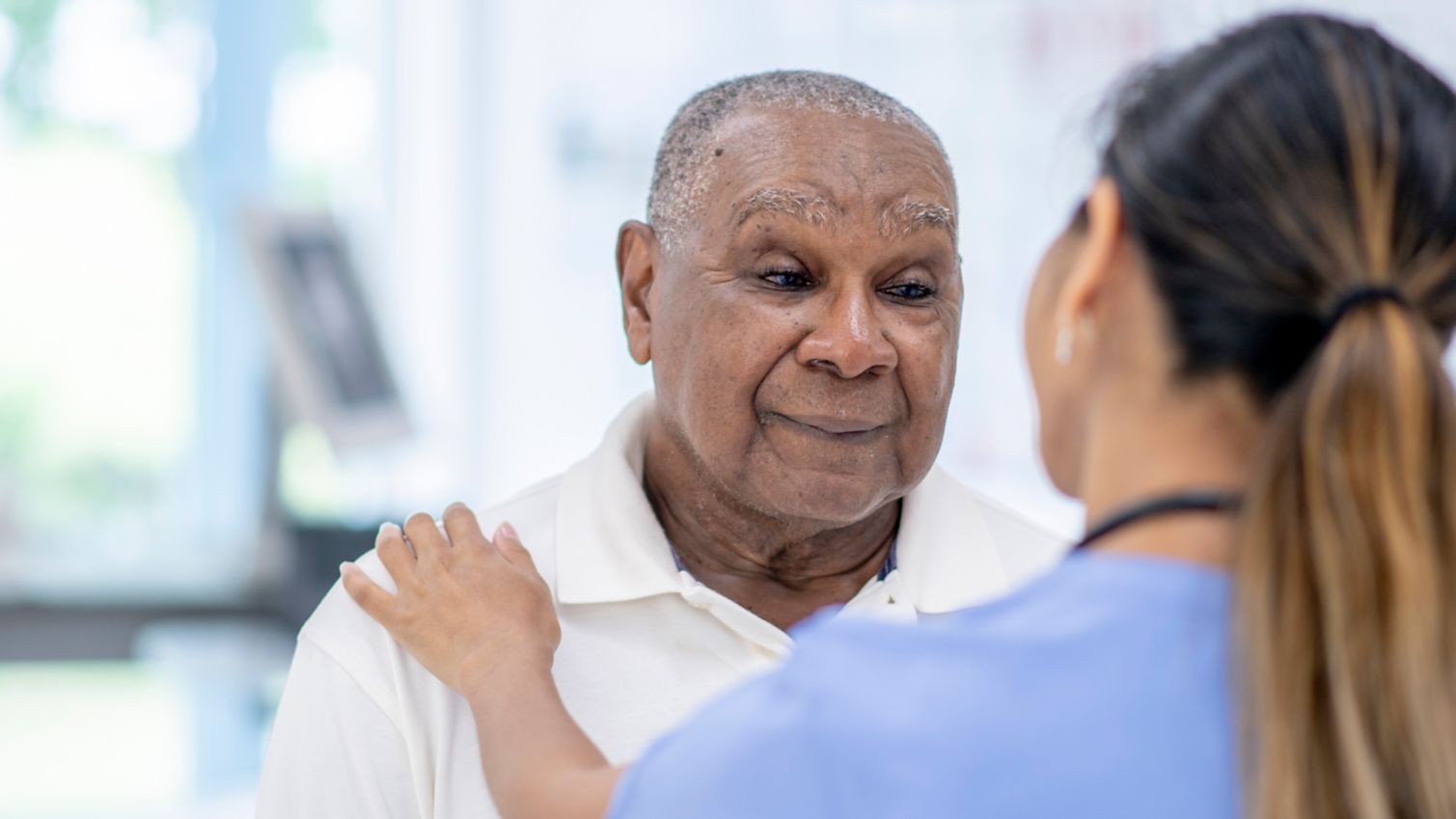 Medicaid doctor comforts senior patient